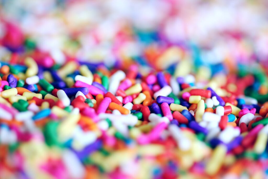 Close-up of vibrant multicolor candy sprinkles creating a playful and sugary abstract background.